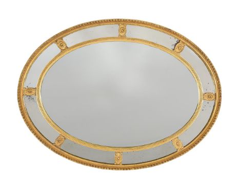 A GILTWOOD AND COMPOSITION OVAL WALL MIRROR IN GEORGE III STYLEEARLY 20TH CENTURY74cm high, 99cm wide