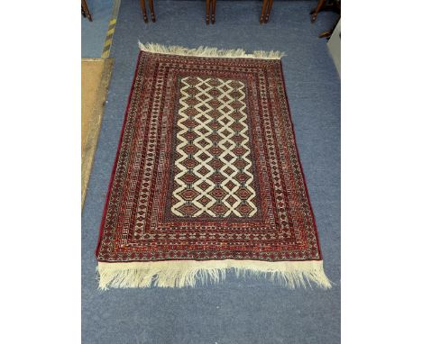 A Persian handwoven rug with motifs on cream ground with multiguard borders on red ground and tasselled ends 166cm x 126cm Lo