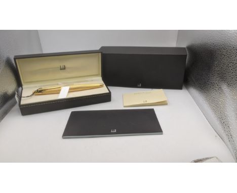A gold plated Alfred Dunhill fountain pen with an 18ct gold nib and engine turned case complete with box, cover and user guid