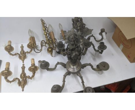 A collection of lighting equipment to include a pair of steel chandeliers with six arms, a brass chandelier with five arms an