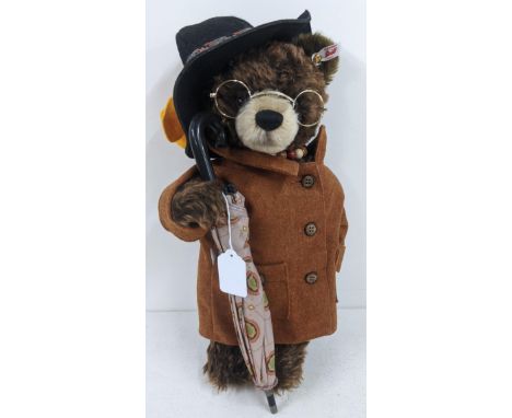 A Steiff Aunt Lucy from the show Paddington bear with a hat, rust coloured jacket, glasses and umbrella 690778, 39 cm HLocati