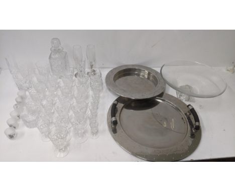 A group of crystal cut glass to include a decanter, brandy glasses, whisky glasses, and other items, along with a glass bowl 
