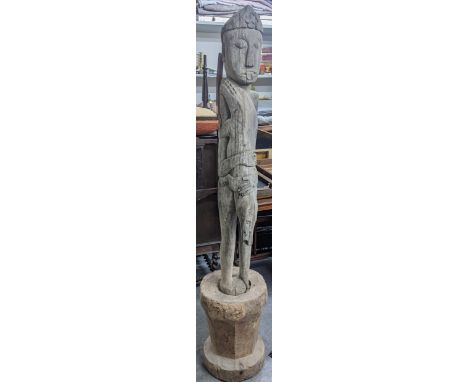 A hardwood carved tall tribal figure having elongated limbs on an integral base, 173cm h Location:If there is no condition re