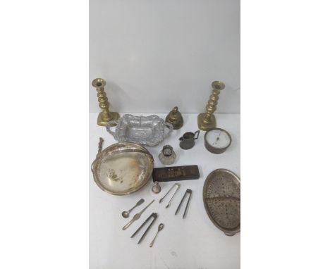 A group of metalware to include a brass bell, a glass inkwell, a pair of nutcrackers, a barometer and other items Location: G