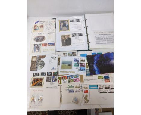 A collection of British First Day cover stamps, along with an album containing partly commemorative and British coinage and o