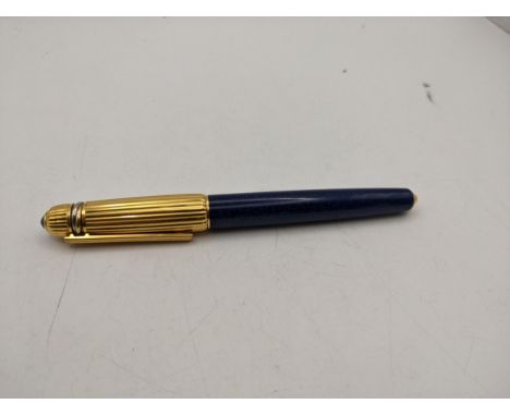 A Pasha de Cartier rollerball pen in blue with a gold plated ribbed lid with cabochon sapphireLocation:If there is no conditi