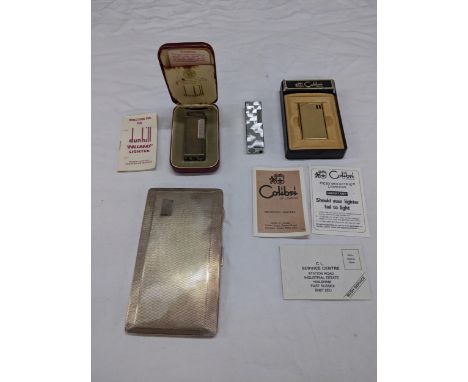 Vintage smoking related items to include a boxed Dunhill rollagas lighter with user guide, a boxed Colibri molectric lighter,