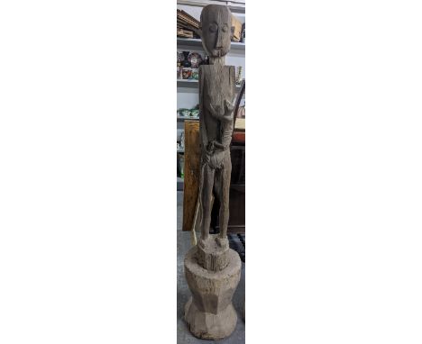 A hardwood carved tall tribal figure having elongated limbs on an integral base, 193.5cm h Location:If there is no condition 