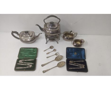 A collection of silver plated items to include a spirit kettle with burner stand, two boxed pairs of nutcrackers, a sugar bow
