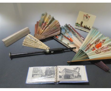 A painted fan and a bone and lace fan together with two other fans, a small postcard album and a QEII Coronation tile and a h