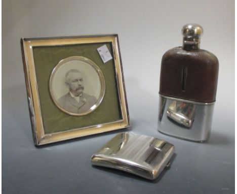 A silver photograph frame with circular mount and silver ship, a pocket cigarette case and a hip flask (3)  