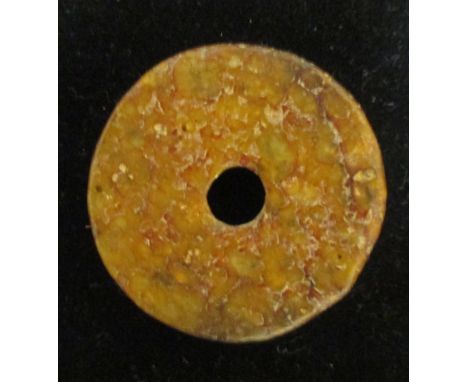 A Chinese jade bi and another in brown stone  
