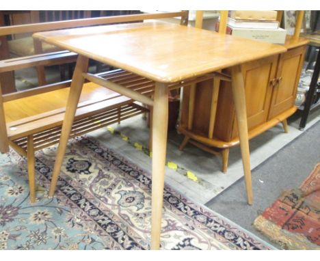 An Ercol light elm dining table and matching chair with plate rack  