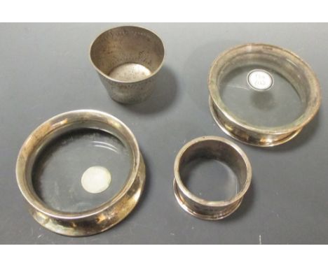 Two glass based silver coasters and a napkin ring  