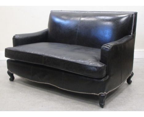 A black leather upholstered two seater sofa  