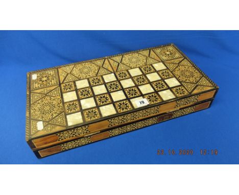 A backgammon set, complete with mother of pearl inlay