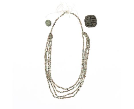 Egypt, a faience scarab and a faience necklace, Late Period. Herewith a stone large round amulet with a carved udjat at the b