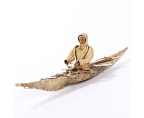 Greenland, Inuit, model kayak, showing a kayak covered in animal skin, several accessories on top and in the centre a figure 