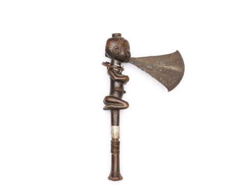 D.R. Congo, Luba, axe, the blade issues from the squatting female's mouth. H. 44,5 cm. [1]