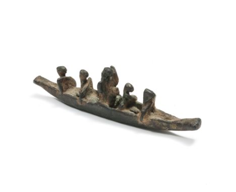 A antique bronze sculpture of five figures in a boat, the middle figure seated on a animal and wearing a shield. L. 17,5 cm. 