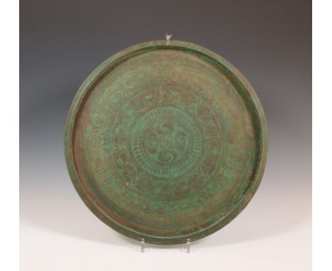 Java, a fine bronze dish, talam, 12th-14th century, with engraved decor of flowers and foliage.  diam. 46 cm.  Collection Asi