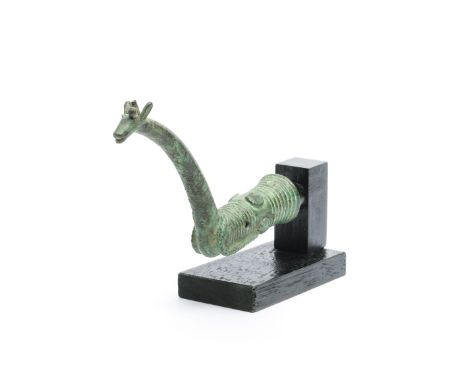 Luristan, a bronze handle of a whetstone in the shape or a representing a deer, ca. 1000 BC. L. 11,5 cm. on wooden stand. Pro