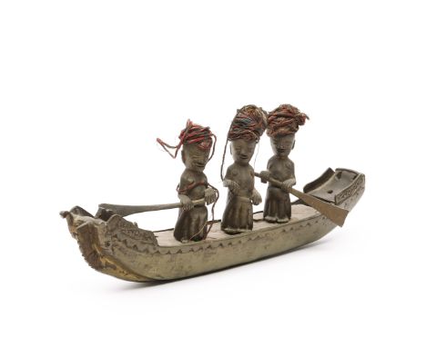 Sumatra, Batak, a bronze miniature boat with three ancestor figures, ca. 1900. (one oar missing) L. 25 cm. [1]