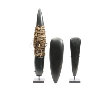 Papua, two stone axe blades and a currency stone blade the centre wrapped in plant fiber with cowry chell.  h. 21 / 24 and 36