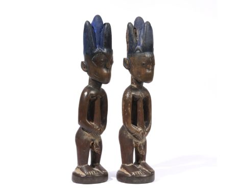 Nigeria, Yoruba, Egbe, a pair of male twin figures, ibeji, the hands encircle the belly button, traces of indigo blue in the 