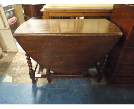 An Oak Drop Leaf Barley Twist Gate Legged Dining Table