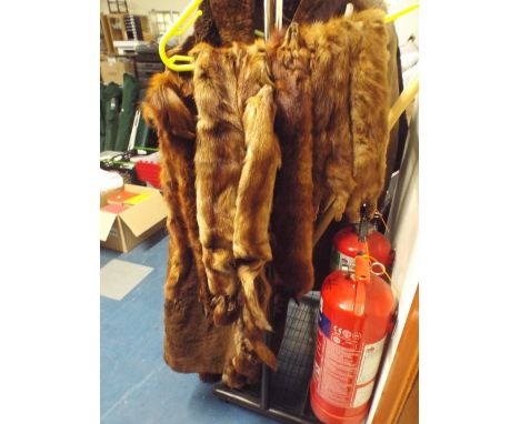 A Collection of Fur Stoles and a Faux Fur Coat