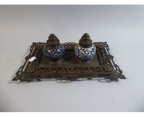 A Victorian Ceramic and Brass Desk Top Ink Stand with Pierced Tray, Two Blue and White Ink Bottles, 30cm Wide