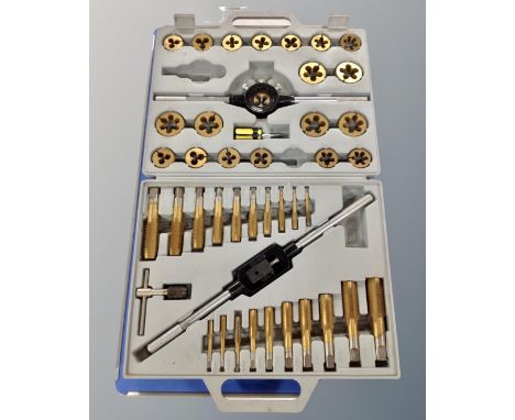 A heavy duty metal bench vice together with a tungsten tap and die set in case 