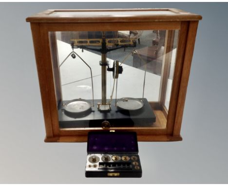 A set of vintage chemist's balance scales in case and a Bakelite cased set of weights 
