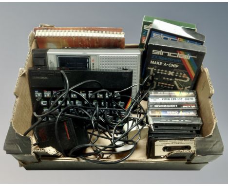 A Sinclair ZX Spectrum with leads and games and a Dixons cassette recorder 