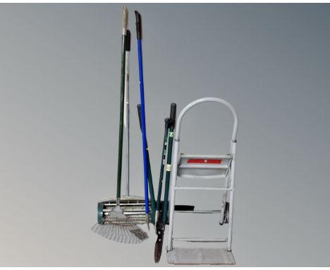A lawn aerator together with a metal sack barrow / folding step and garden tools 