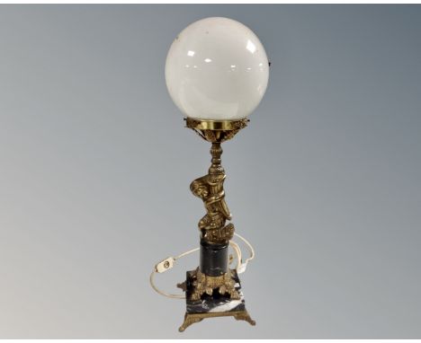 A gilt metal and black marble figural table lamp with opaque ball glass shade (base as found) 