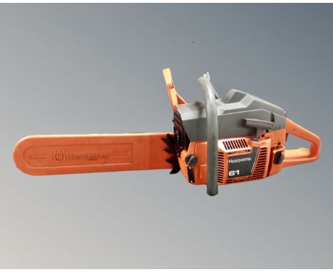 An Husquarna 61 petrol chainsaw with instruction book 