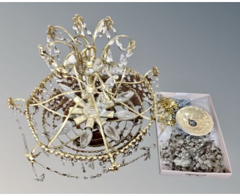 A vintage brass light fitting with brass drops 