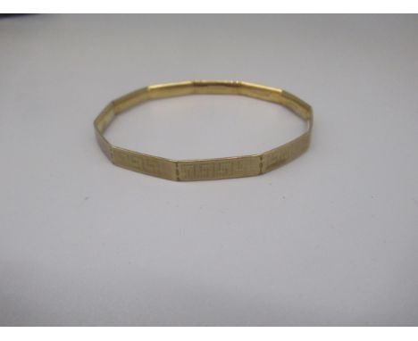 9ct yellow gold eleven sided bangle with engraved Greek Key design, stamped 9c, 17.9g 