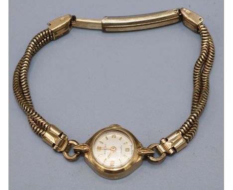 Lady's Rotary gold hand wound wristwatch, signed silvered dial with applied Arabic and baton hour markers, two piece case hal
