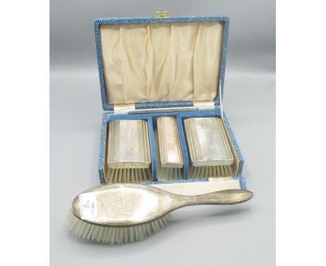 ERII cased silver four piece dressing table set, Daniel Manufacturing Company, Birmingham 1958 and a silver backed hair brush