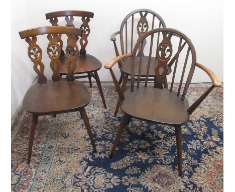 Pair of Ercol elbow chairs with arched backs, circular gold labels, and a pair of Ercol dining chairs, both stamped and one w