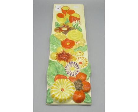 Clarice Cliff rectangular wall plaque, moulded in relief with flowers, 42.5x12cm, Clarice Cliff Wilkinson Ltd stamp 