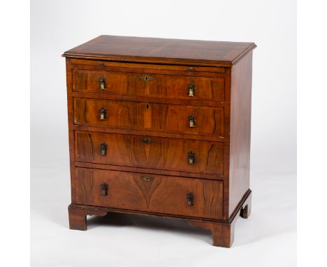 A walnut chest, circa 1920, of four drawers with brushing slide on bracket feet, 76.5cm wide