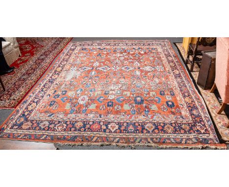 A Mahal carpet, West Persia, early 20th Century, the madder field with allover floral design within indigo samovar borders, 3