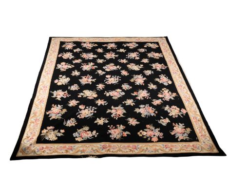 An Aubusson style wool carpet decorated a field of flower sprays and bouquets on a black background within a floral border, 3