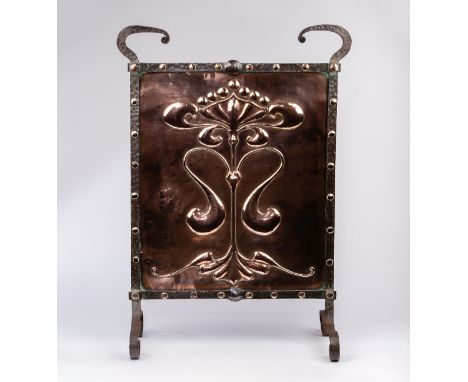 An Arts &amp; Crafts copper firescreen/embossed a central anthemion motif, the planished steel frame with circular copper bos