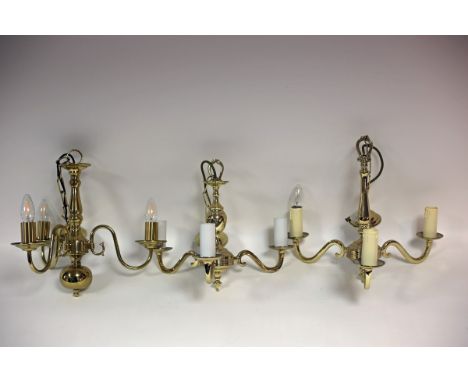 A Dutch brass three-light chandelier with scroll branches, a three-light chandelier and another