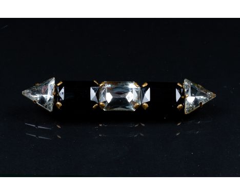 A vintage fashion bar brooch, of alternating black and clear stones in metal mounts, 11cm wide